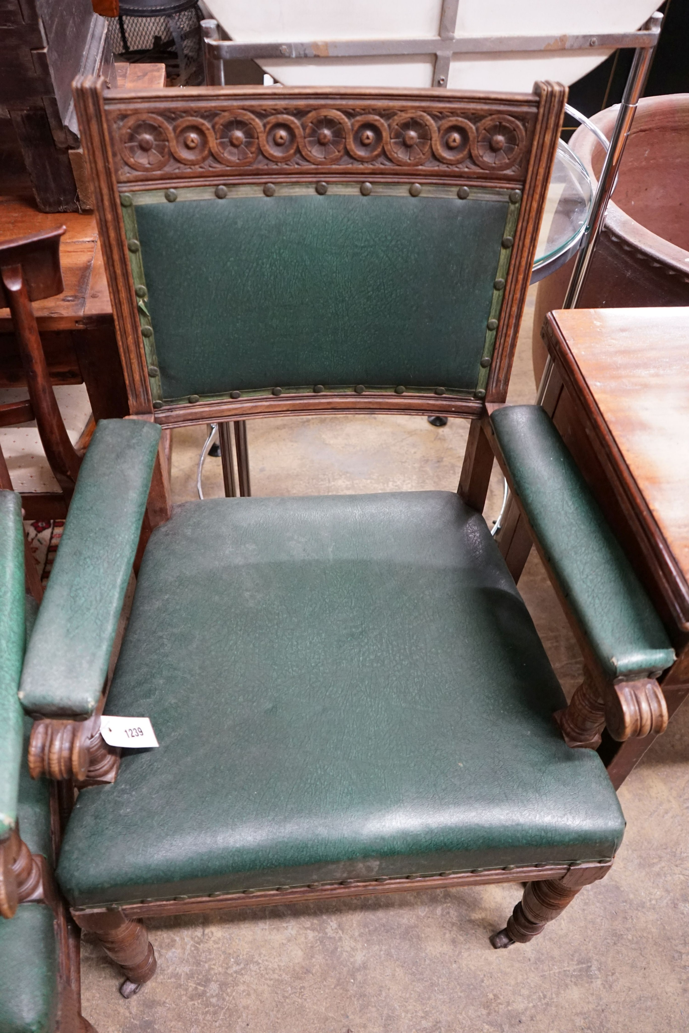 A pair of late Victorian carved oak elbow chairs, width 60cm, depth 53cm, height 100cm